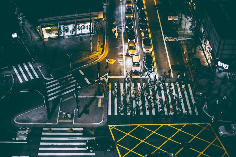 High angle view of a crowded city intersection with pedestrians and traffic at night