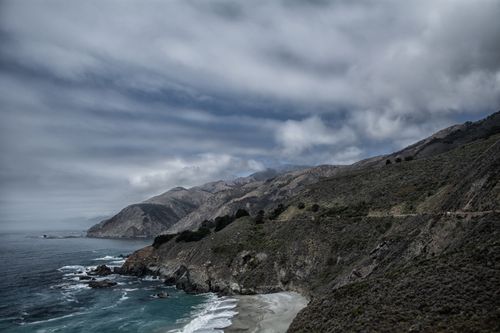 Free Scenic view of dramatic coastal cliffs under a cloudy sky, capturing nature's raw beauty. Stock Photo