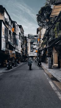 City street scene with narrow alleys and motorcycles, depicting vibrant urban life.