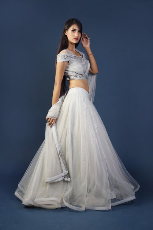 Free A stylish and graceful woman in a traditional white saree and elegant pose, showcasing cultural attire. Stock Photo