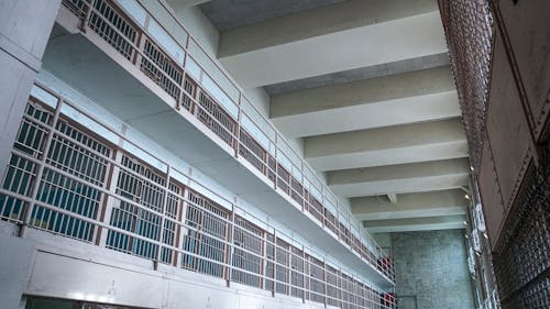 White Concrete Building With White Metal Window Grills