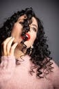 Sensual young with curly hair and mouth opened in studio