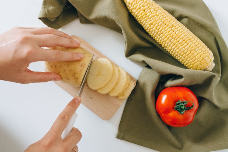 A Person Slicing Potato