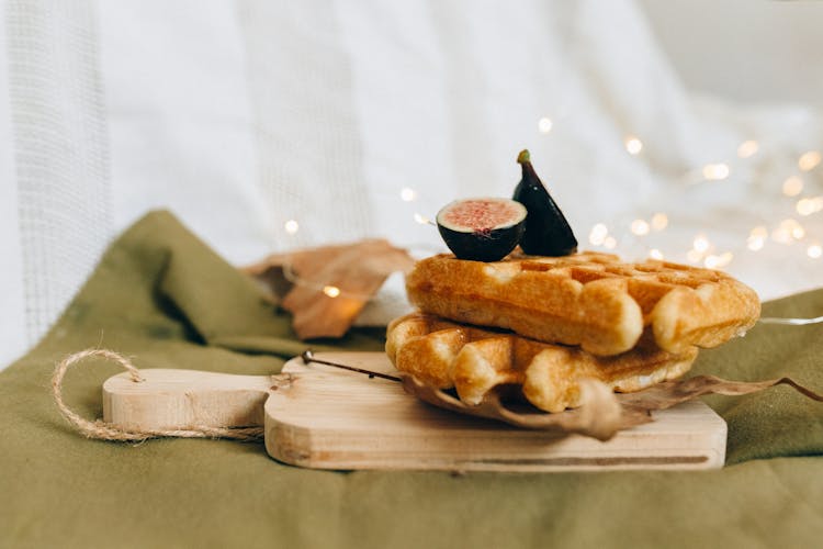 Waffles With Sliced Fruit On A Wooden Chopping Board