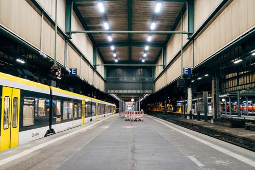 Free Interior view of a modern train station with a yellow train on the platform in Stuttgart, Germany. Stock Photo