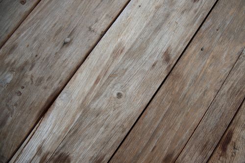 Free Detailed close-up view of aged, rustic wooden planks showing natural texture and grain. Stock Photo