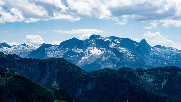 Explore the stunning snowy peaks and lush forests of the Bavarian Alps, perfect for nature lovers.