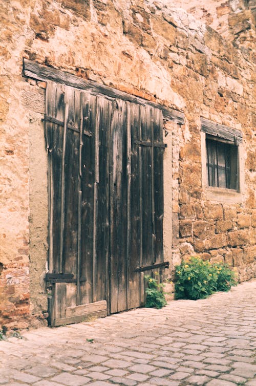 Wooden Door on Brown Brick Wall