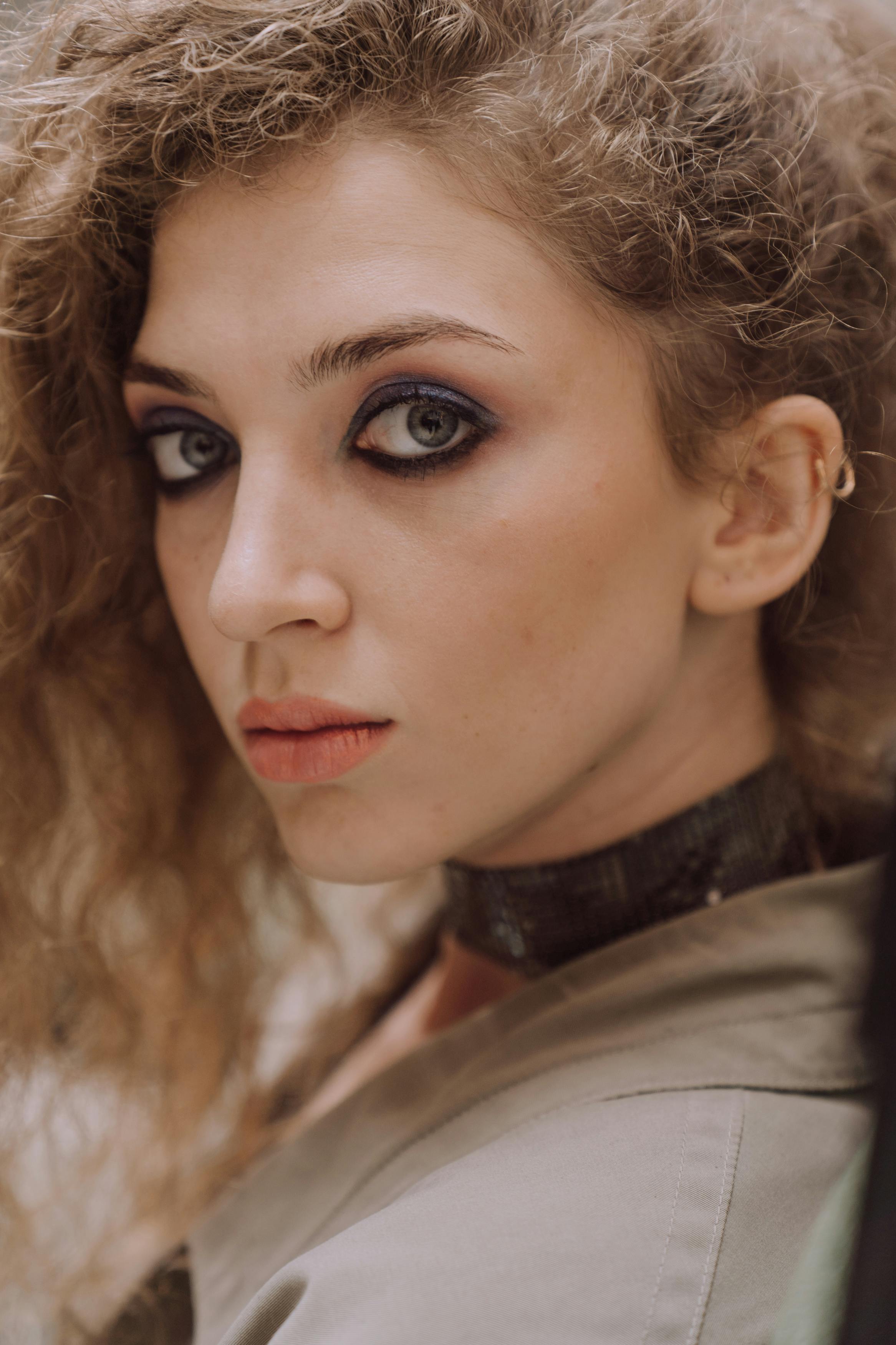 woman with curly hair looking at camera