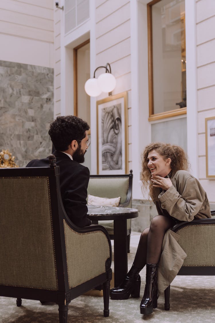 Man And Woman Talking At Restaurant Patio