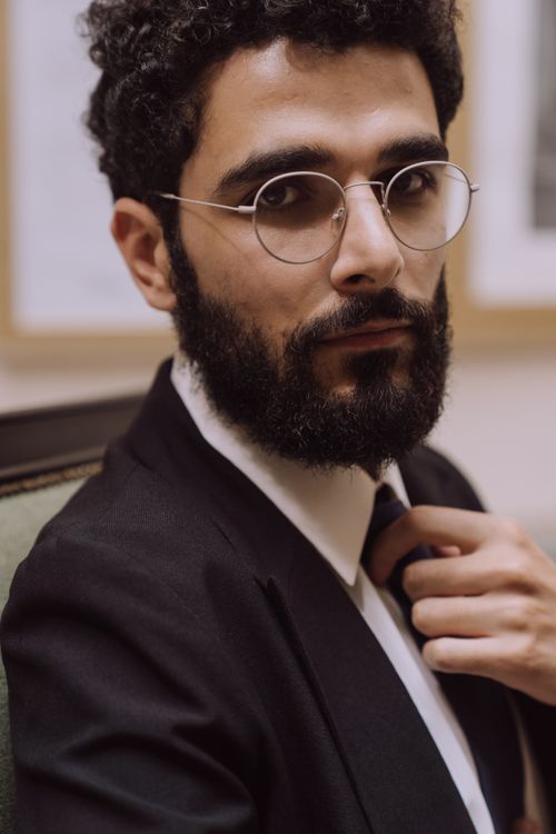 Free Portrait of a stylish bearded man wearing eyeglasses, exuding confidence and elegance. Stock Photo