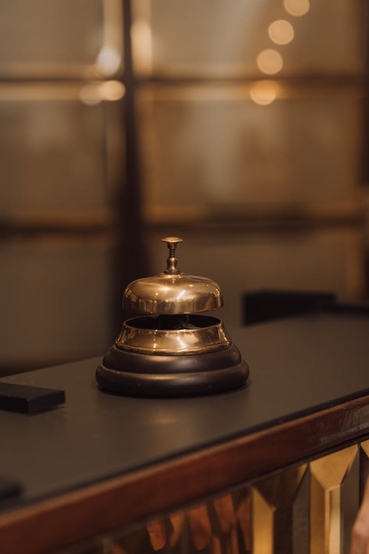 Close-Up Of Gold Bell On Desk