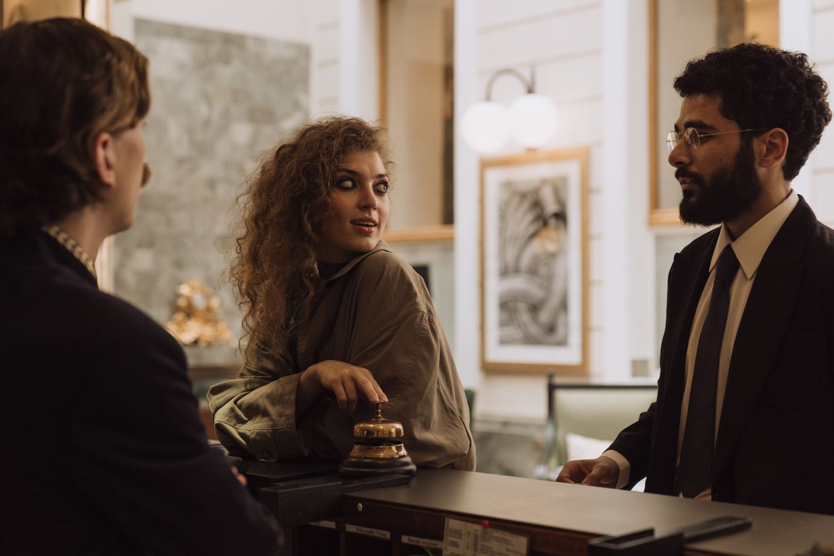 Professional hotel reception manager greeting guests