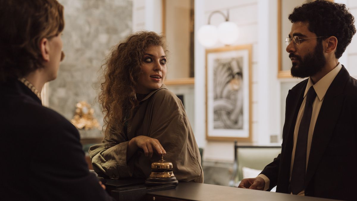 Guests checking in at a hotel reception
