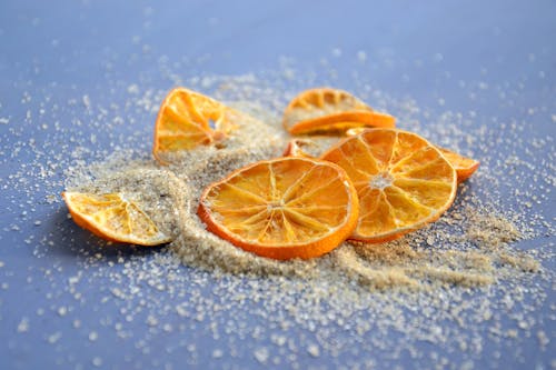 Dried Slices of Orange Fruit with Sugar on Blue Surface