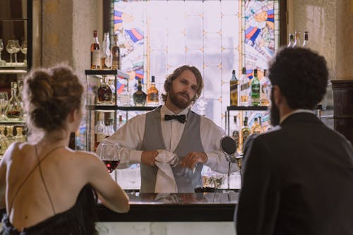 Bartender Serving a Couple at a Bar