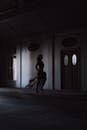 Silhouette of Woman Running on Hallway