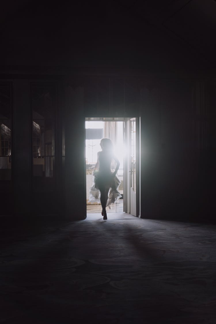 Silhouette Of A Woman In Dress Running