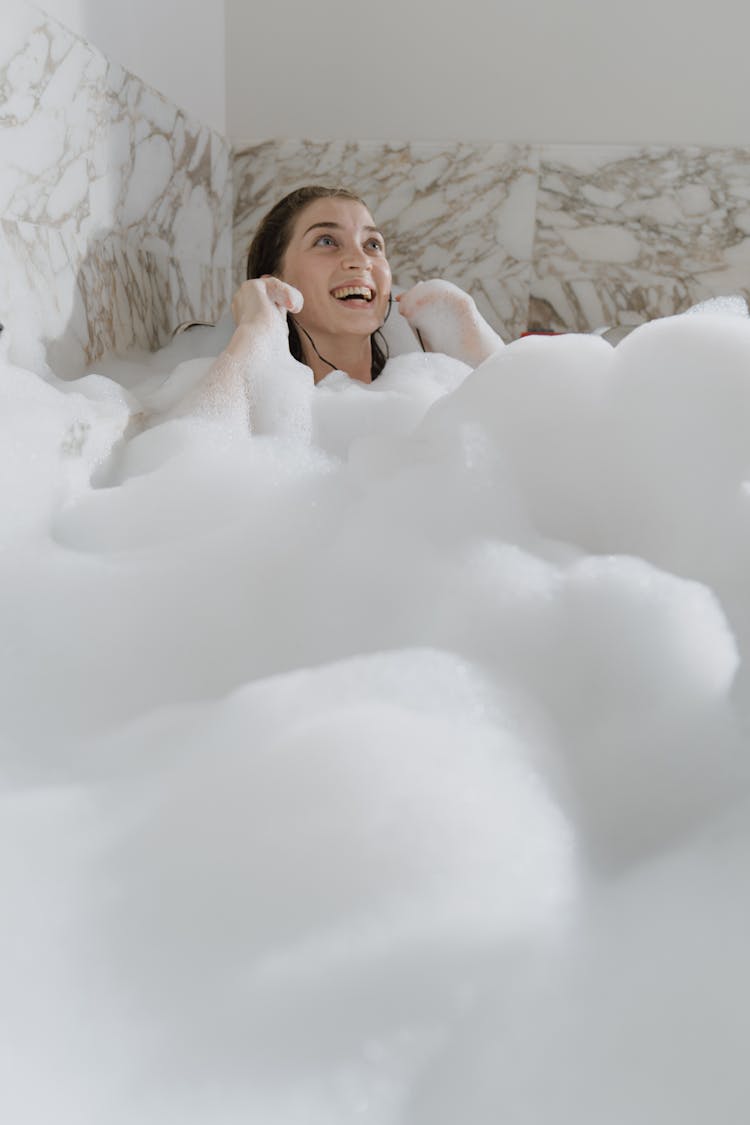 Woman In A Bathtub Listening To Music