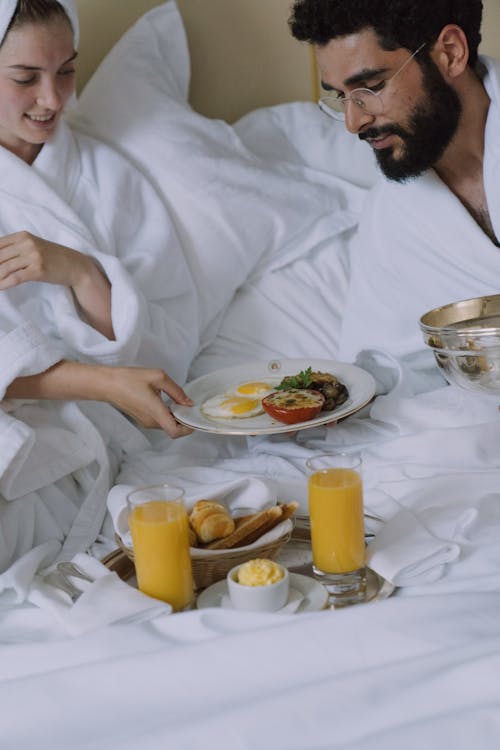 Free Couple Having Breakfast in Bed Stock Photo
