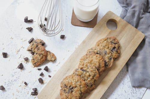 Free Cookies and Glass of Milk on White Surface Stock Photo