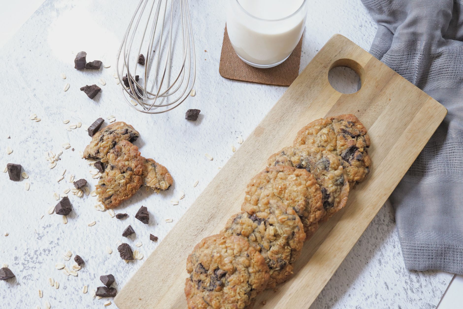 Close-up of dark healthy chocolate chips scattered around cookies