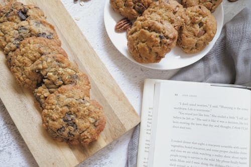 Free Baked Cookies and a Book on White Surface Stock Photo