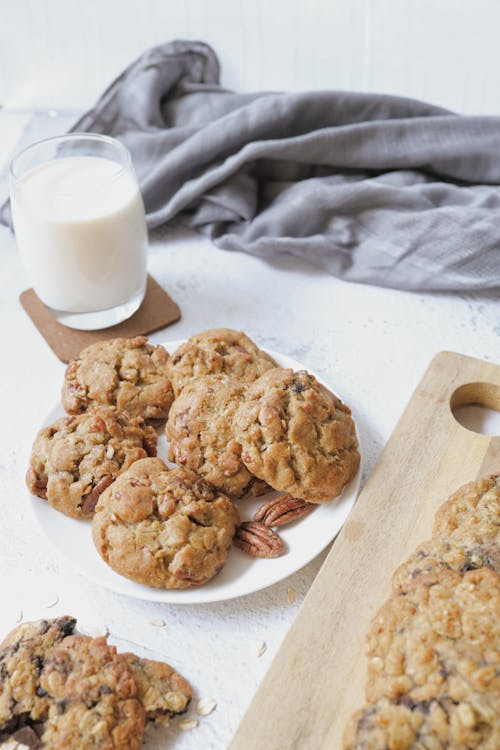 Free Cookies and a Glass of Milk on White Surface Stock Photo