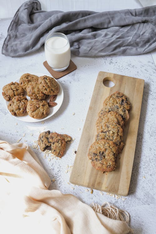 Free Cookies and a Glass of Milk on White Surface Stock Photo