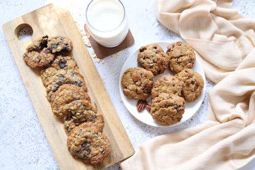 Free Cookies and a Glass of Milk on White Surface Stock Photo