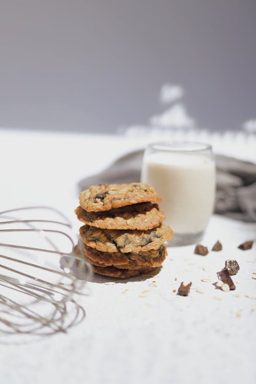 Free Cookies and a Glass of Milk on White Surface Stock Photo