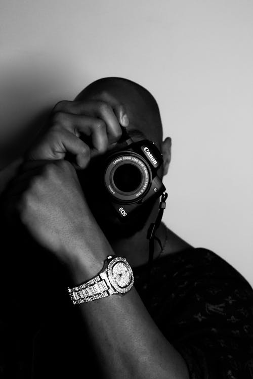 Grayscale Photo of Man Holding Camera