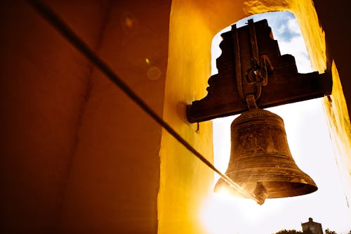 Brass Bell on Yellow Wall