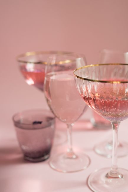 Stylish arrangement of sparkling pink wine glasses against a soft background.