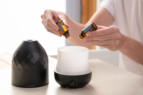 Free Person Putting Essential Oils into a Diffuser Stock Photo