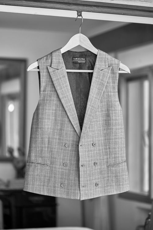 Free Stylish gray vest on a hanger in an indoor setting, perfect for a fashion statement. Stock Photo