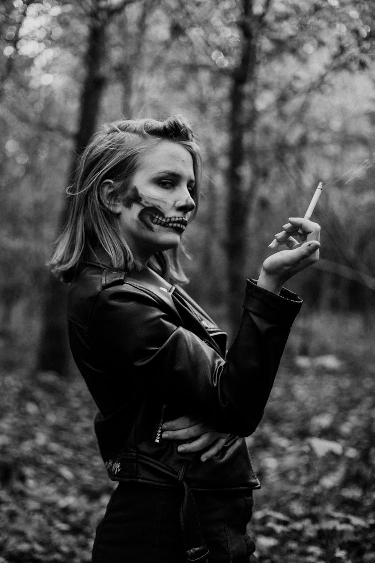 Woman With Skull Makeup Smoking Cigarette