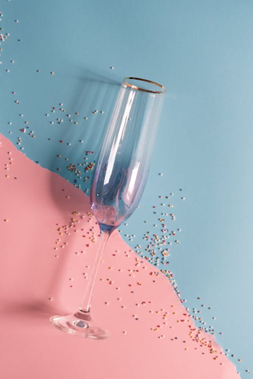 Champagne Glass against a Light Blue and Light Pink Background