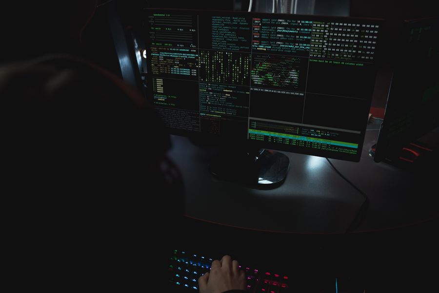 Dark room with code on screens — photo by Tima Miroshnichenko on Pexels
