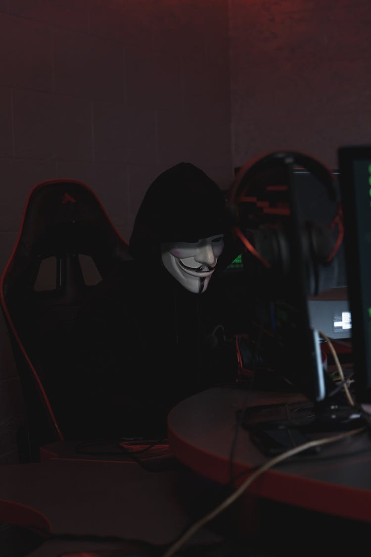 Person Wearing Mask Sitting On Chair