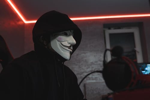 Low-Angle Photo of a Person in Black Hoodie Wearing White Mask