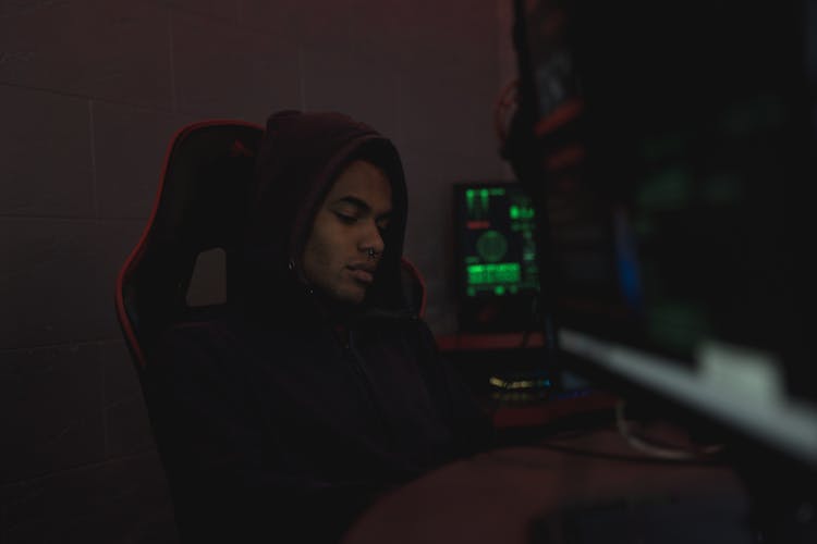 Man In Black Hoodie Sitting On Chair