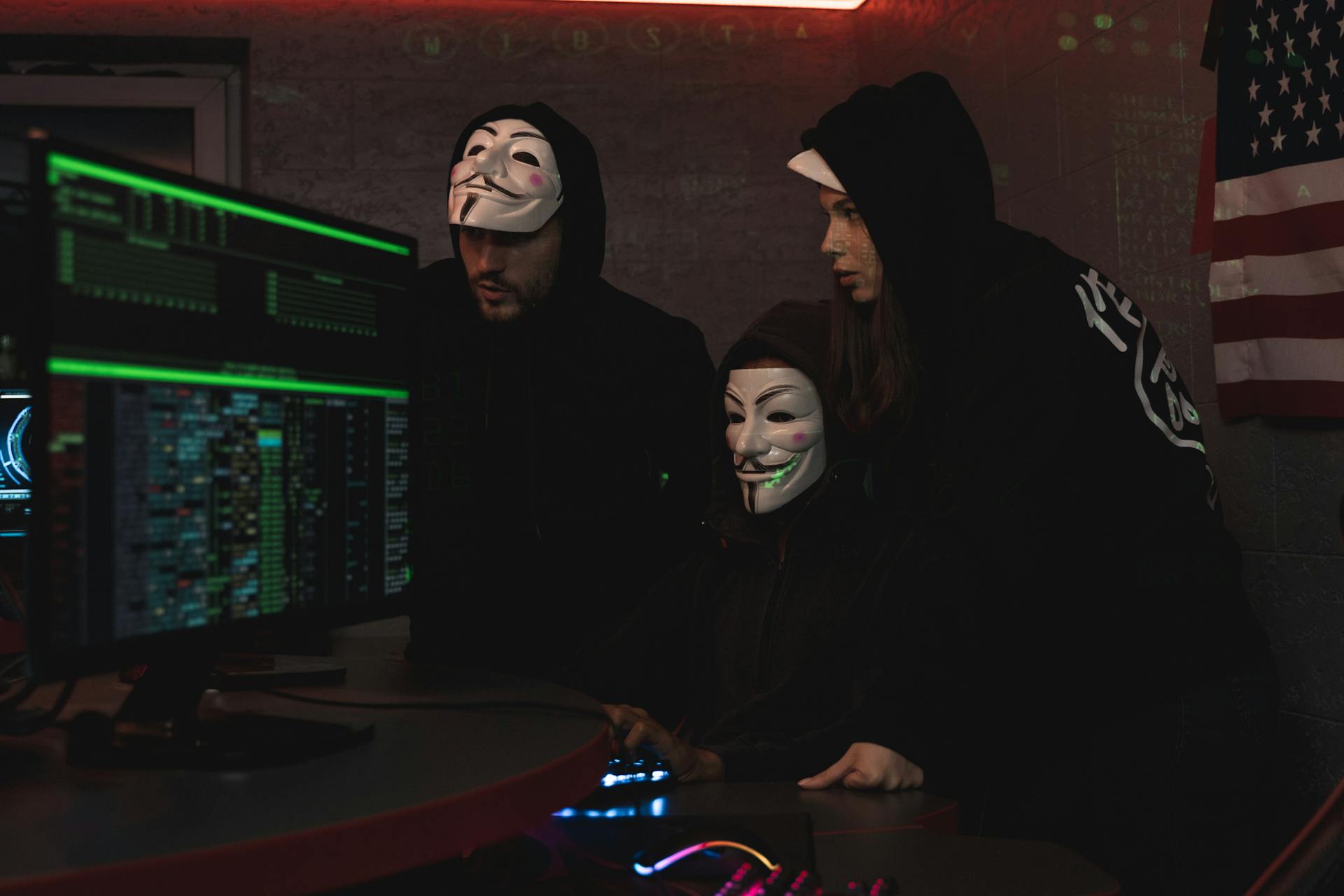 Three People Hacking a Computer System