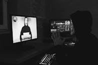 Monochrome Photo of Two People Having a Video Call