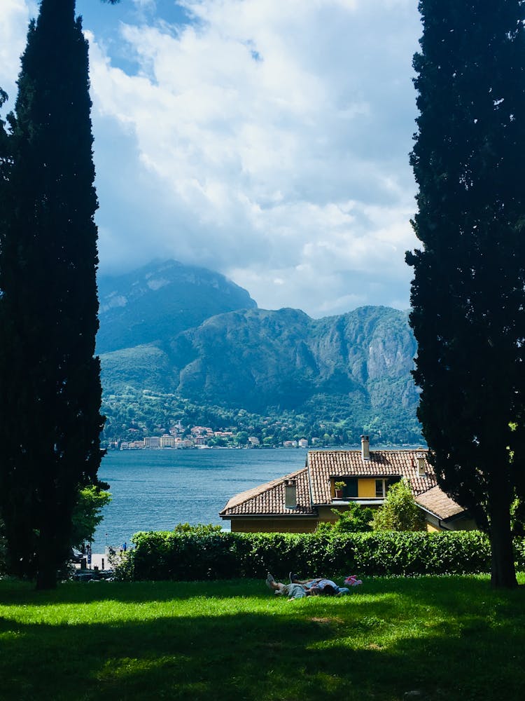 Brown House Near A Lake With Mountain View