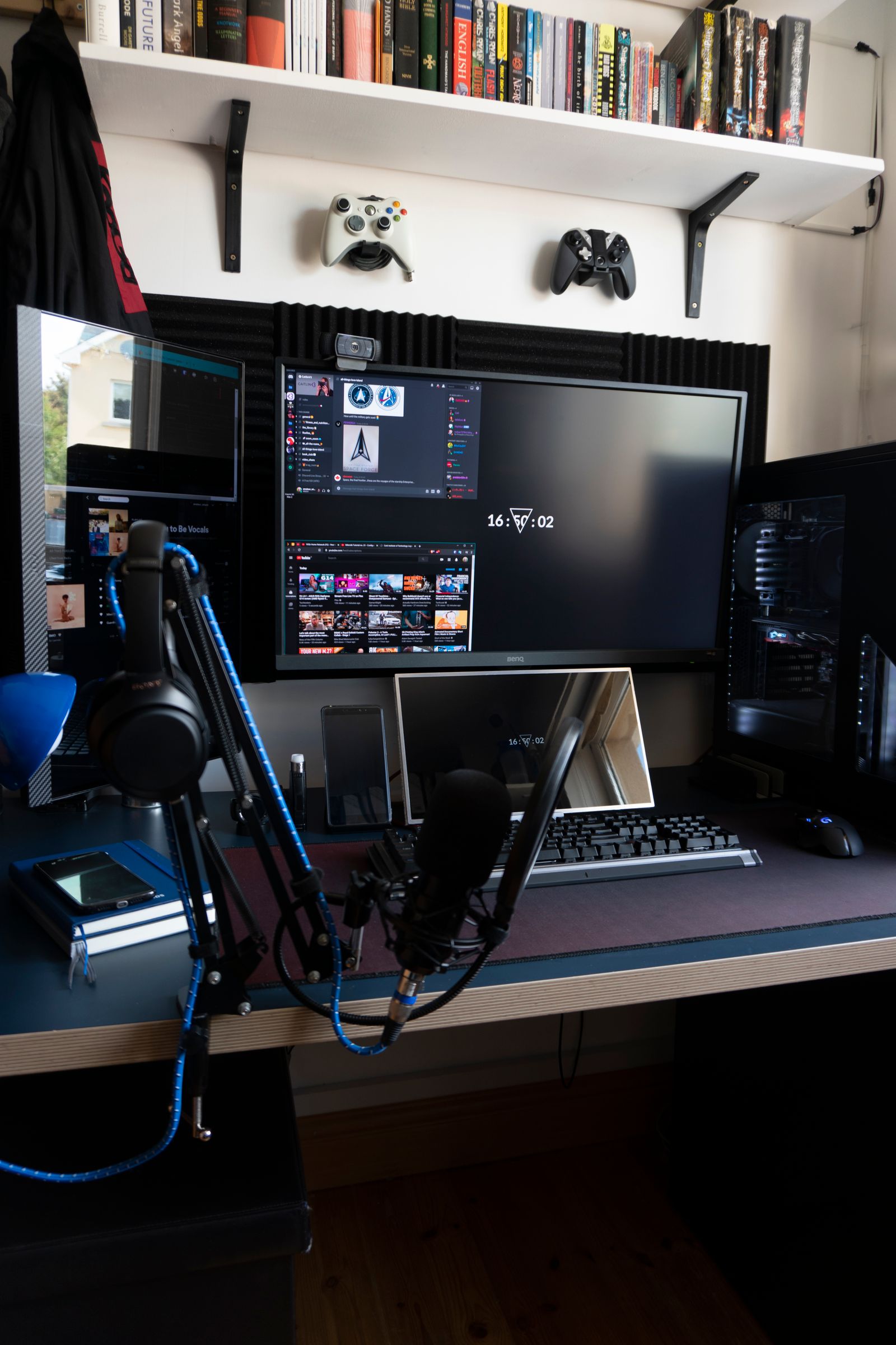 Premium gaming rig with dual monitors, keyboard, mouse, microphone and controllers