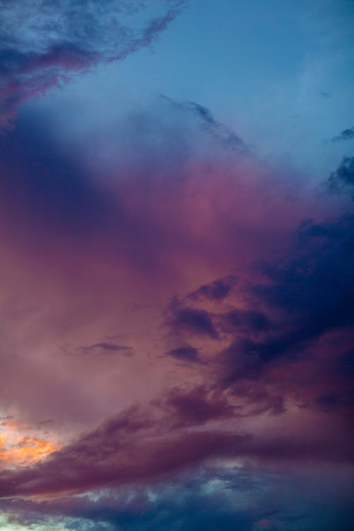 Picturesque scenery of violet and blue sky with clouds at sundown in evening