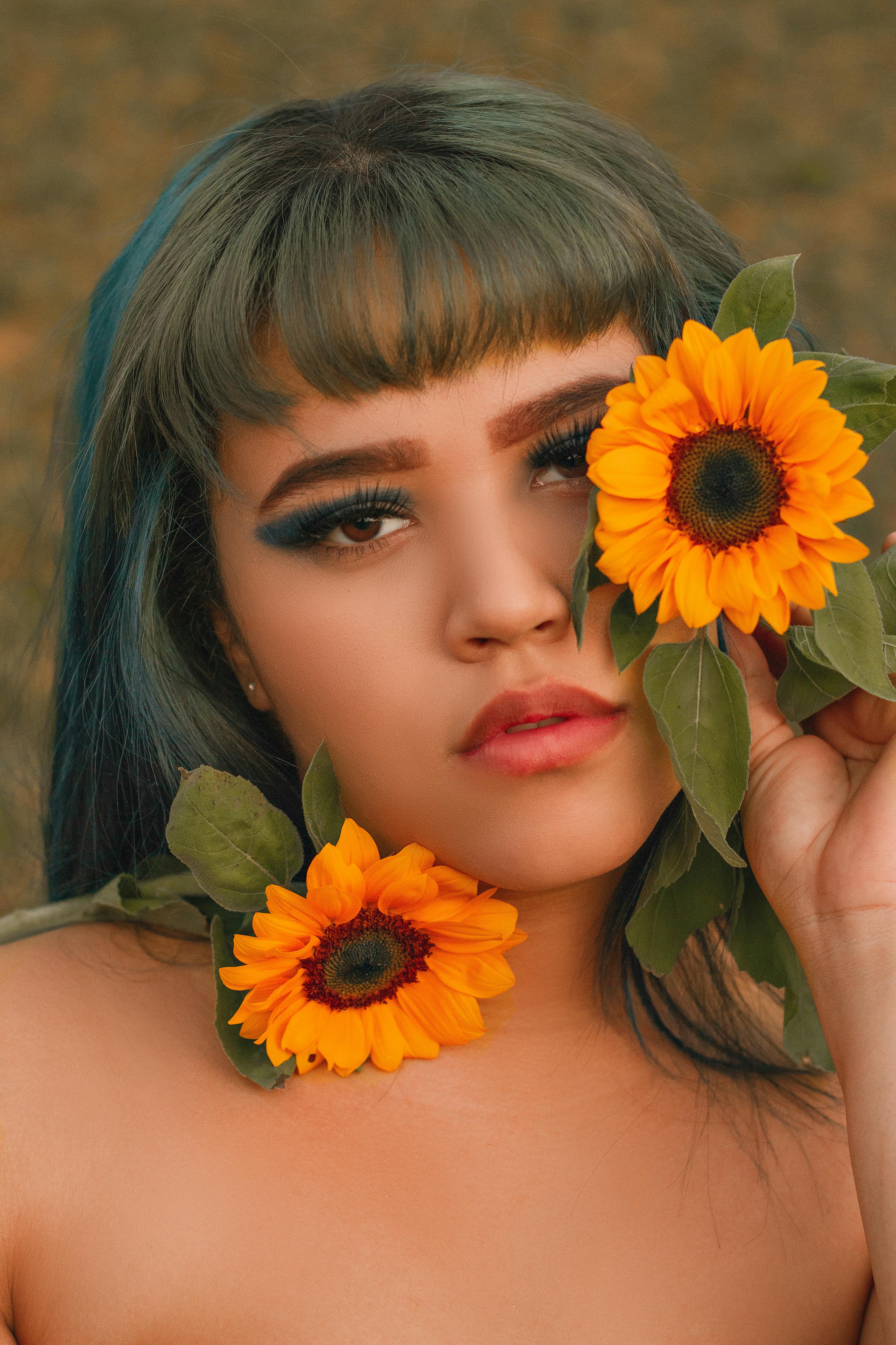 A captivating portrait of a woman with sunflowers, showcasing beauty and nature in vibrant colors.