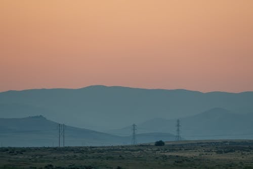 Landscape with electricity poles and mountains