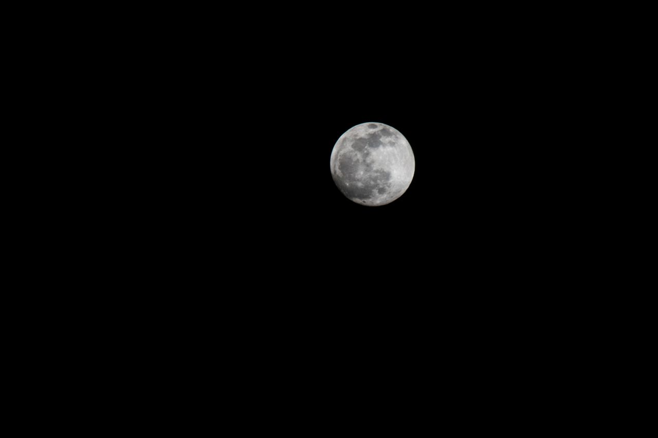 capture of the full moon against a black night sky